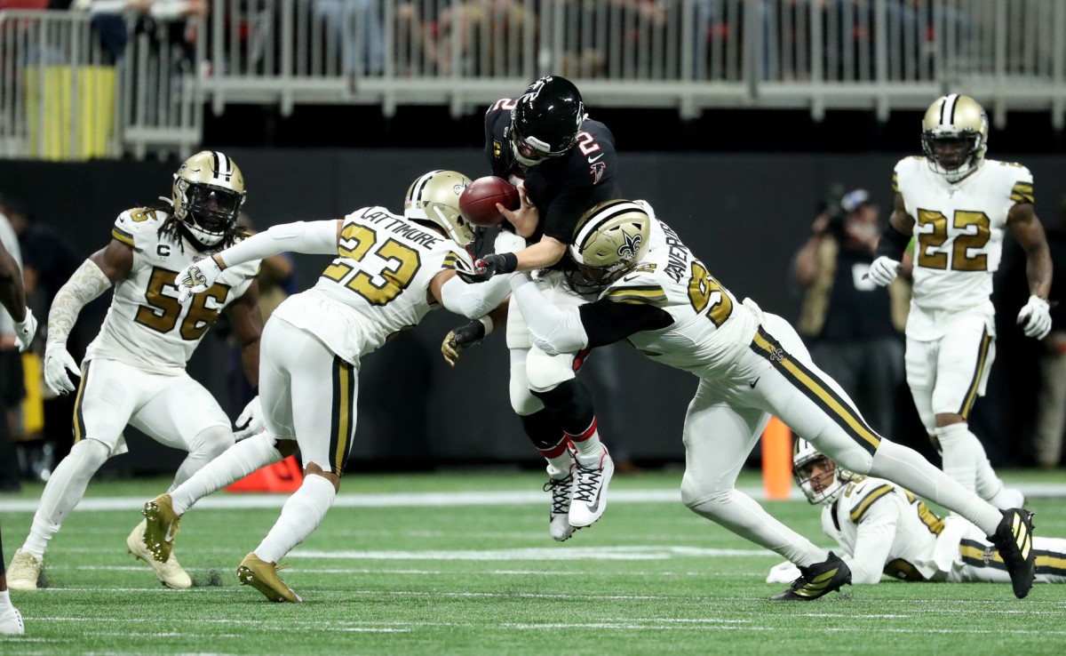 Atlanta Falcons quarterback Matt Ryan (2) fumbles the ball as he is hit by New Orleans Saints cornerback Marshon Lattimore (23) and defensive end Marcus Davenport (92). Mandatory Credit: Jason Getz-USA TODAY Sports